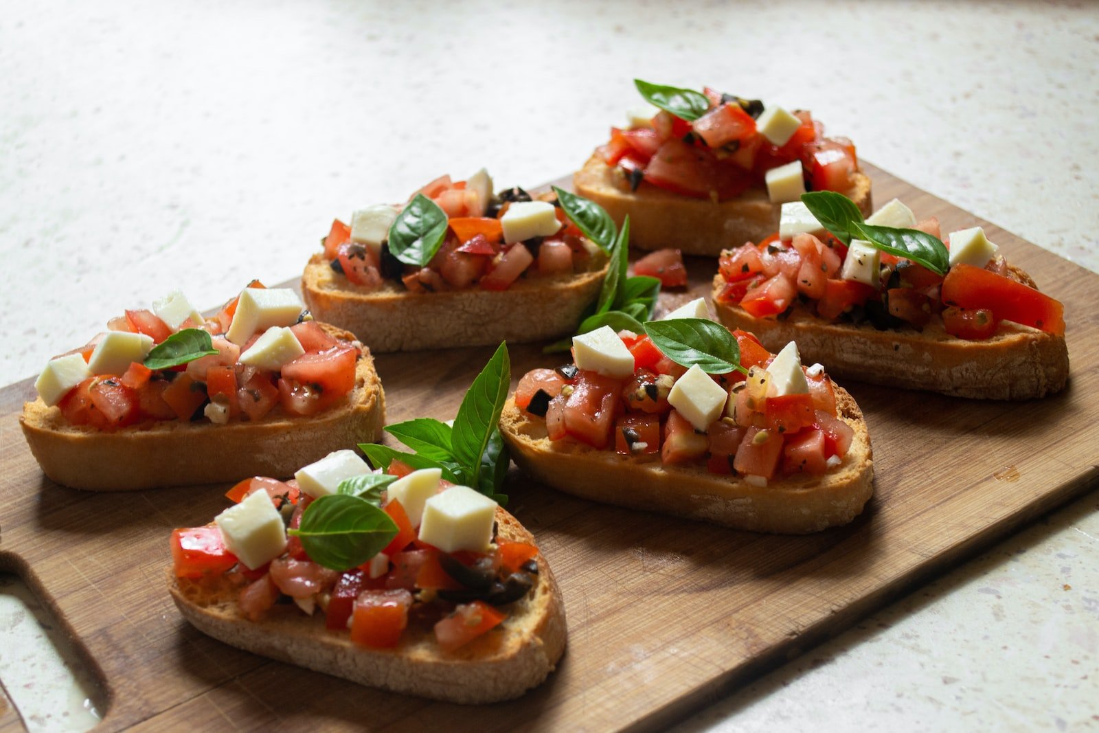 Photo by Konstantinas Ladauskas sliced tomato and green vegetable on brown wooden chopping board